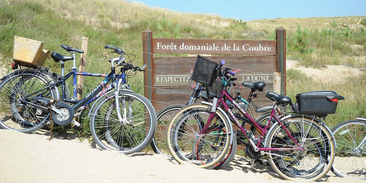 Bikes at the entrance to the sandy path to the beach near Arvert