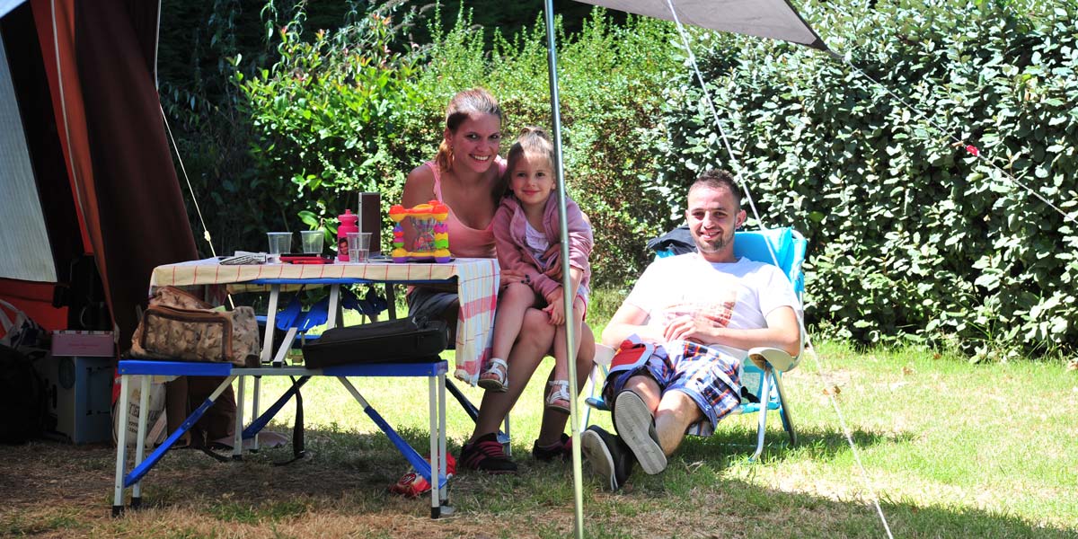 Family of campers in tent site at campsite in Arvert