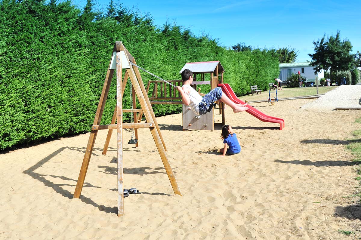 Swing on the playground of the campsite in Charente Maritime