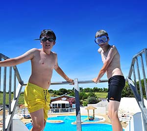 Teenagers in front of the water slide at the Parc de Bellevue campsite in Arvert