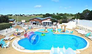Pool with slides and inflatable games at Parc de Bellevue campsite