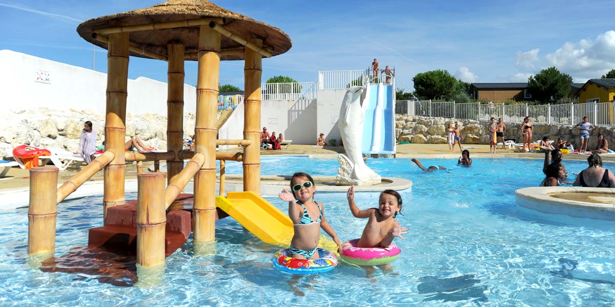 Enfants jouant dans la pataugeoire de l'espace aquatique du camping Parc de Bellevue